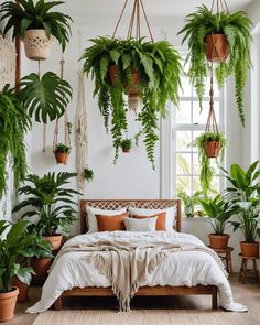 a bedroom with lots of plants hanging from the ceiling and bed in front of it