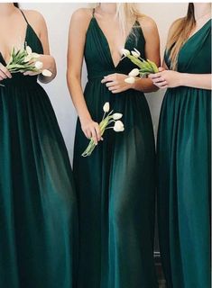 three bridesmaids in green dresses holding flowers