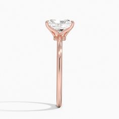 a rose gold ring with an oval cut diamond