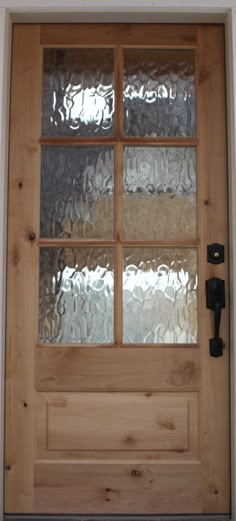 a wooden door with frosted glass on it