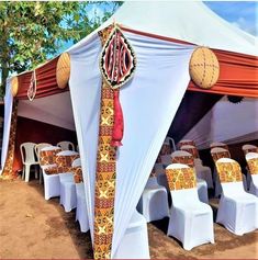 an outdoor tent set up with tables and chairs