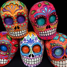 five brightly colored sugar skulls sitting next to each other