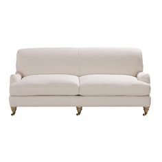 a white couch sitting on top of a wooden floor