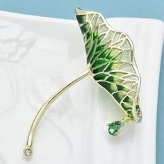 This Is A Brand New Lotus Shaped Pin / Brooch And Its Approximate Measurements Are: 1-7/8" X 1-7/8". Made Out Of Yellow Gold Metal With Green And Clear Colored Stones. The Finished Weight Of The Pin Is 8 Grams. Br0429 Elegant Green Flower Brooches, Gold Brooches For Spring Gift, Elegant Green Enamel Pin For Gift, Elegant Green Enamel Pin Gift, Gold Brooch Jewelry For Spring, Spring Gold Brooch Jewelry, Spring Gold Jewelry Brooch, Spring Season Gold Brooch Jewelry, Spring Green Brooch Gift