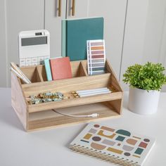 a desk with a phone, binder and other office supplies on top of it