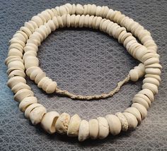 Wonderful white seashell beads (can also function as beadcaps) from Ghana in West Africa. Use them as they are or make something beautiful with them! You may not get the one pictured, but a similar strand. Festival White Gemstone Beads, Artisan Adjustable Shell Necklace With Round Beads, White Shell Necklace With Large Round Beads, Handmade Spiritual Shell Necklace With Round Beads, White Large Beads For Crafting, Large White Beads For Crafting, Unique White Shell Necklace With Round Beads, Bone Horn, Trade Beads