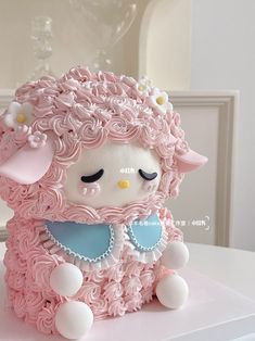 a cake shaped like a sheep with pink frosting