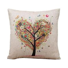 a decorative pillow with a tree and balloons in the shape of a heart on it