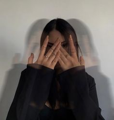 a woman covering her face with both hands