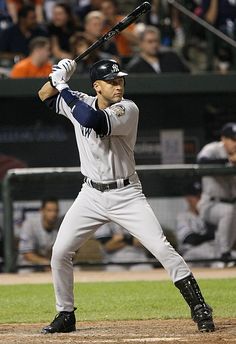 a baseball player holding a bat on top of a field in front of a crowd