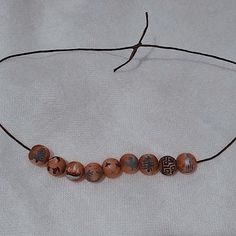 a beaded necklace with wooden beads on a string