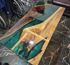 a table made out of wood and glass on top of a marble flooring area