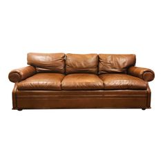 a brown leather couch sitting on top of a white floor