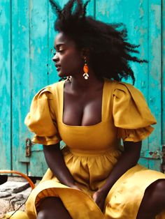 a woman in a yellow dress sitting on the ground