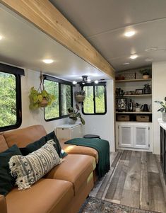 a living room filled with furniture and windows next to a counter top freezer oven