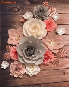 paper flowers are arranged on a wooden surface