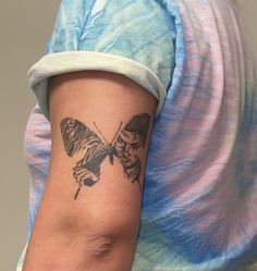 a woman with a butterfly tattoo on her arm