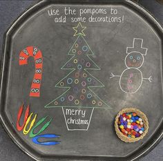 a chalk board with christmas decorations on it