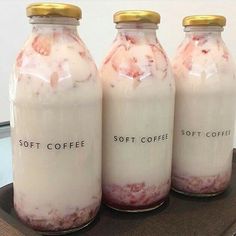 three jars filled with liquid sitting on top of a table