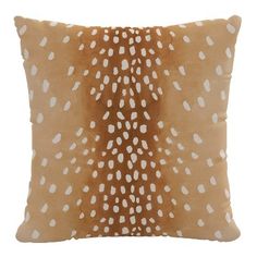 a brown and white pillow with spots on it