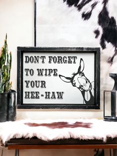 a sign that says don't forget to wipe your here - haw on it