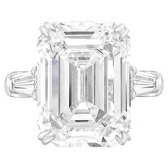 This breathtaking 10.03 ct emerald cut diamond ring exudes timeless elegance. The center stone, a GIA-certified diamond, boasts exceptional F color and VVS1 clarity, making it truly rare. Set in a sophisticated 18K White Gold band, the ring is flanked by two tapered baguette diamonds that enhance the centerpiece's brilliance. With excellent polish and symmetry, every facet reflects light to perfection. Additionally, the diamond is free of fluorescence, allowing its natural beauty to shine throug Emerald Cut Diamond Engagement, Contemporary Engagement Rings, Emerald Cut Diamond Ring, Platinum Diamond Rings, Modern Engagement Rings, Engagement Ring Diamond Cut, Contemporary Ring, Emerald Cut Diamond, Platinum Engagement Rings