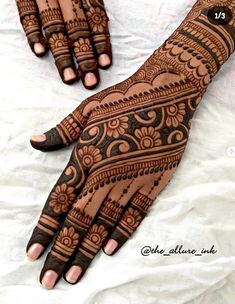 two hands with henna designs on them, one is black and the other is brown