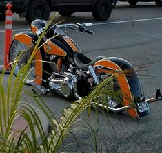 an orange and black motorcycle parked on the street