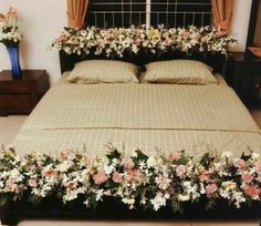 a bed with flowers on the head board