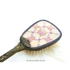 a brush that is sitting on top of a white furnishing area with an ornate design