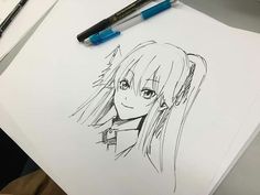 a drawing of a girl with long hair and blue eyes is on a piece of paper