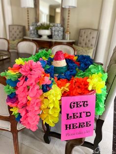 a table with a sign that says get let's here and flowers on it