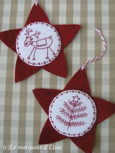 two red and white christmas ornaments on a table