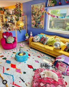 a living room filled with lots of colorful furniture and decor on top of a white rug