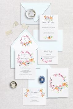 the wedding stationery is laid out on top of each other, including an envelope and two