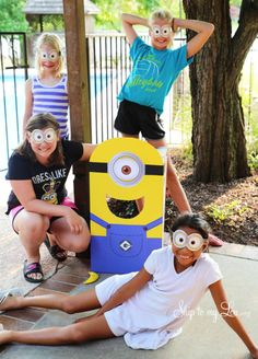 three children with their faces painted to look like minion