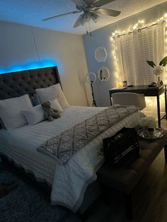 a bedroom with lights on the ceiling and a bed in it's center area