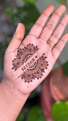 a woman's hand with a henna tattoo on it