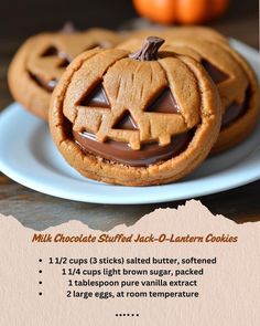 two pumpkin shaped cookies on a white plate with chocolate frosting in the shape of a jack - o'- lantern