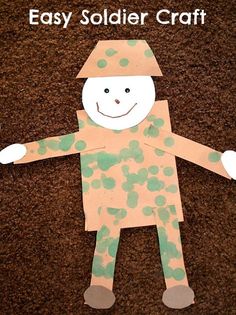 an image of a paper doll made to look like a soldier with green spots on it