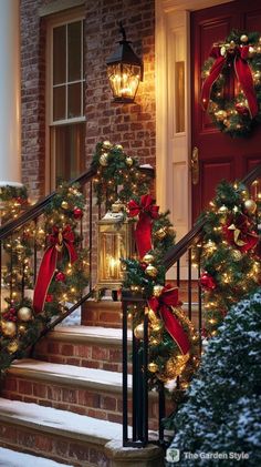 christmas wreaths and lights are on the steps in front of a house