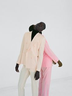 two black men in pink and white suits