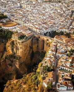 an aerial view of a city and its surrounding cliffs