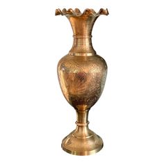 an ornate gold vase is shown on a white background