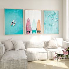 three surfboards are hanging on the wall above a white couch in this living room