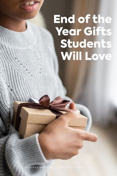 a young boy holding a gift box with the words end of the year gifts students will love