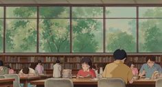 people sitting at tables in a library with bookshelves and trees outside the windows