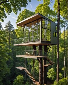 a tall tree house in the middle of a forest with stairs leading up to it