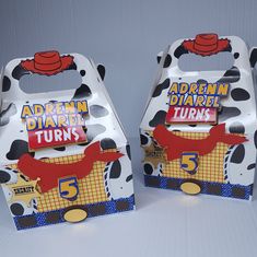 there are two boxes that have different designs on them, one has a cow and the other has a red hat