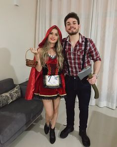 a man standing next to a woman in a costume